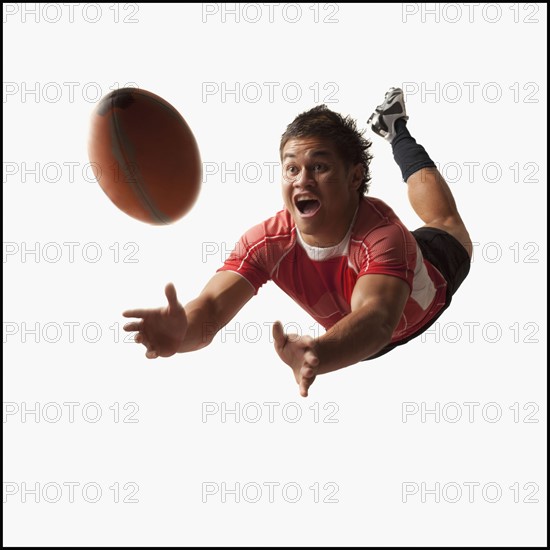 Male rugby player diving for ball. Photo : Mike Kemp