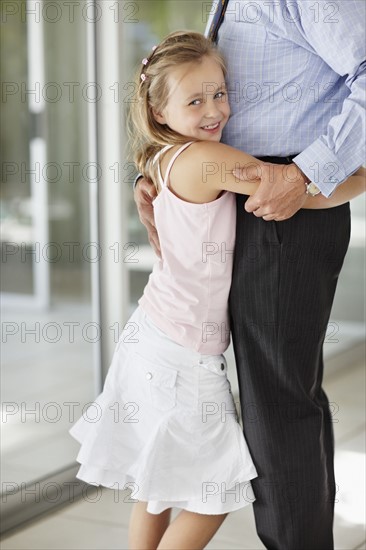 Granddaughter (10-11) hugging grandfather. Photo : Momentimages