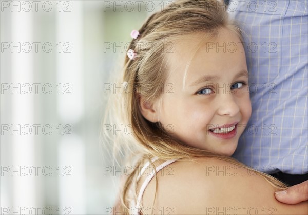 Granddaughter (10-11) hugging grandfather. Photo : Momentimages