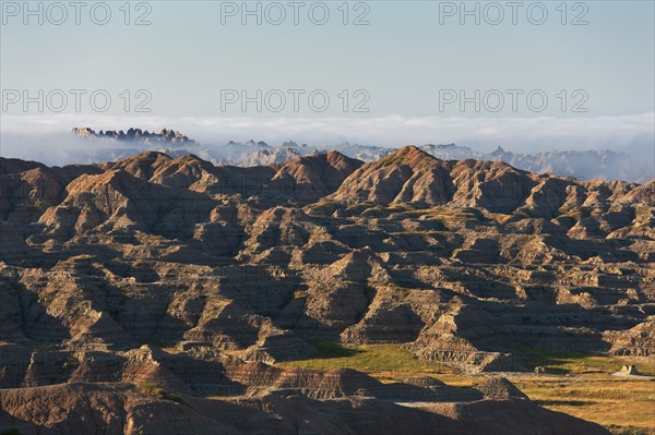 USA, South Dakota, Mountains in morning fog in Badlands National Park.