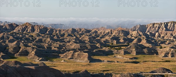 USA, South Dakota, Mountains in morning fog in Badlands National Park.