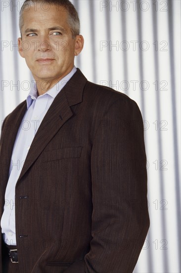 Handsome man wearing suit. Photo : Fisher Litwin