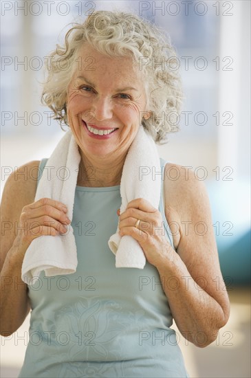 USA, New Jersey, Jersey City, Portrait of senior woman with towel at gym.