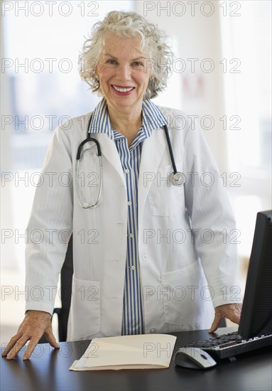 USA, New Jersey, Jersey City, Portrait of senior female doctor in office.