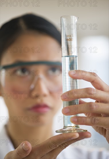 USA, New Jersey, Jersey City, Female scientist holding chemical test tube.