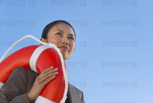 USA, New Jersey, Jersey City, Woman carrying life belt.