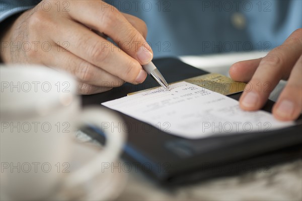 Man signing bill.