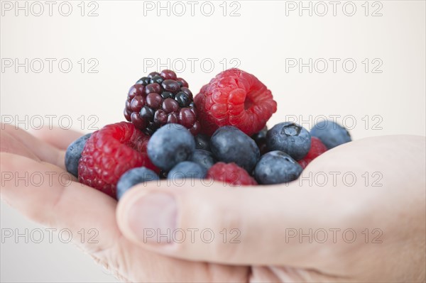 Fresh fruits on male hand.