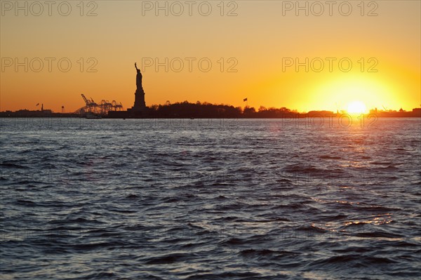 USA, New York City, Staten Island, Harbor and silhouette of Statue of Liberty in background.