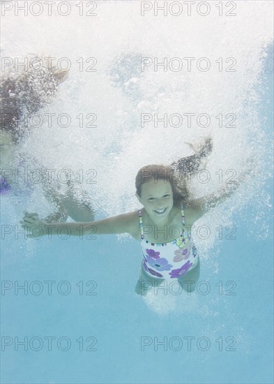 USA, New York, Girls (10-11, 10-11) in swimming pool. Photo : Jamie Grill Photography