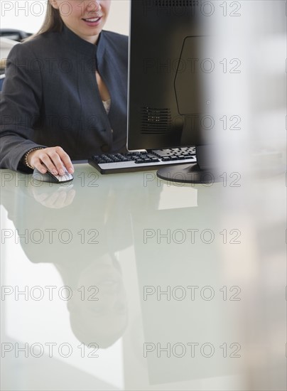 USA, New Jersey, Jersey City, Businesswoman working on computer. Photo : Jamie Grill Photography