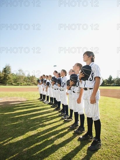 USA, California, Ladera Ranch, little league players (aged 10-11) on field.