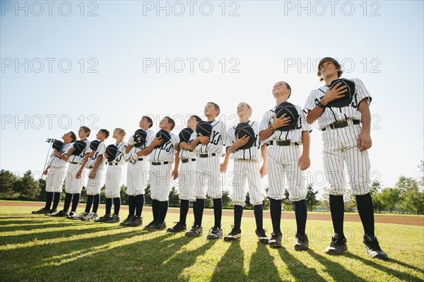USA, California, Ladera Ranch, little league players (aged 10-11) on field.