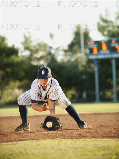 Boy (10-11) playing baseball.