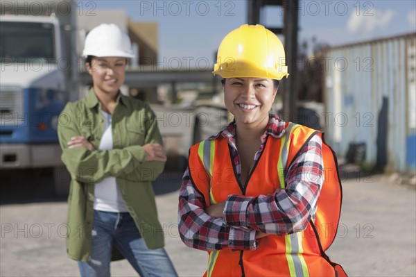 Portrait of two female construction workers on building site. Photo : Dan Bannister