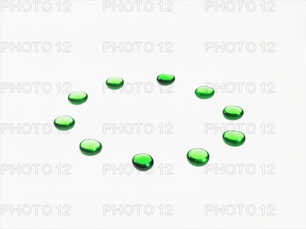 Studio shot of green glass beads in circle. Photo : David Arky