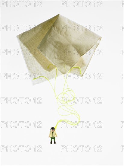 Studio shot of figurine with paper parachute. Photo : David Arky