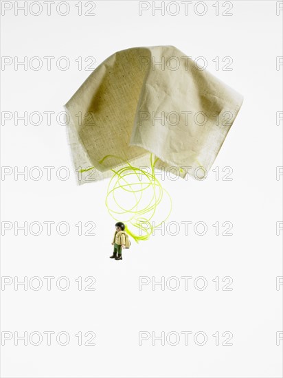 Studio shot of figurine with paper parachute. Photo : David Arky