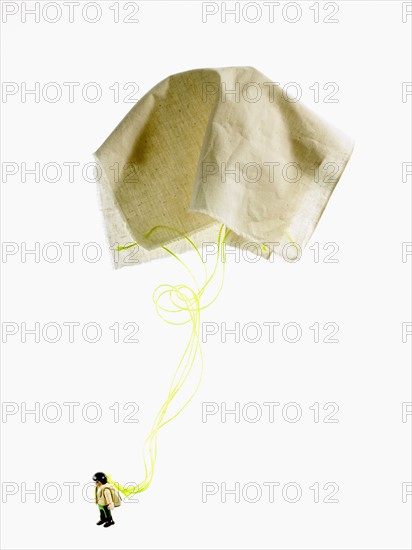 Studio shot of figurine with paper parachute. Photo : David Arky