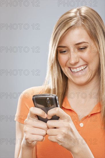 Studio portrait of young woman text messaging. Photo : FBP