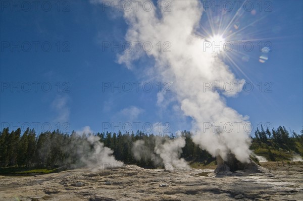 USA, Wyoming, Sun over steaming thermal pool. Photo : Gary J Weathers