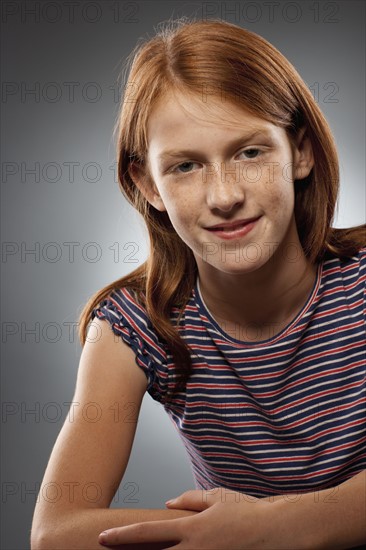 Portrait of redhead girl (10-11), studio shot. Photo : FBP