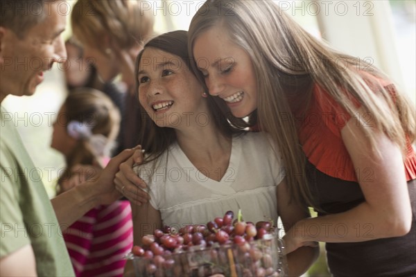 Girl (10 -11,) with family during celebration event. Photo : Tim Pannell