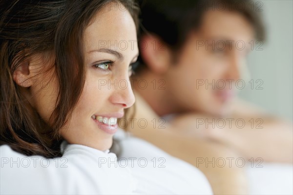 South Africa, Young couple smiling and looking away, focus on foreground. Photo : momentimages