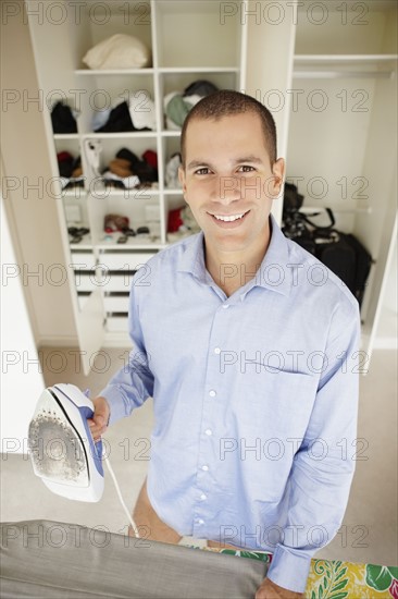 South Africa, Portrait of young man holding iron. Photo : momentimages