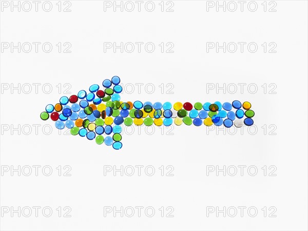 Studio shot of colorful glass beads in arrow shape. Photo : David Arky