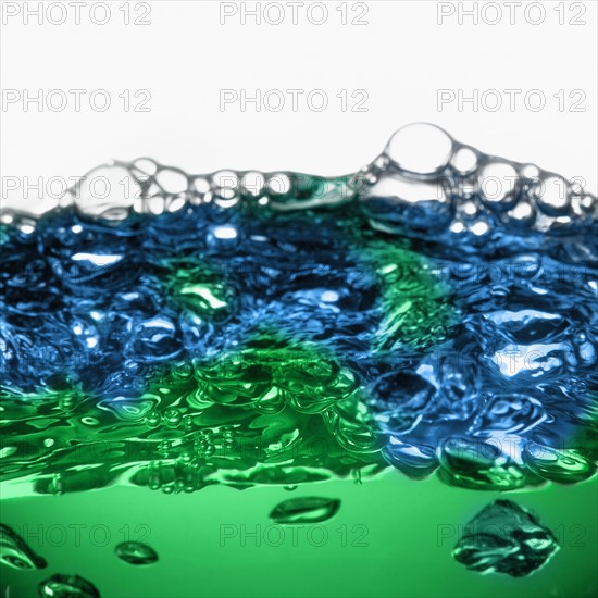 Close up of blue and green water surface with bubbles. Photo : David Arky