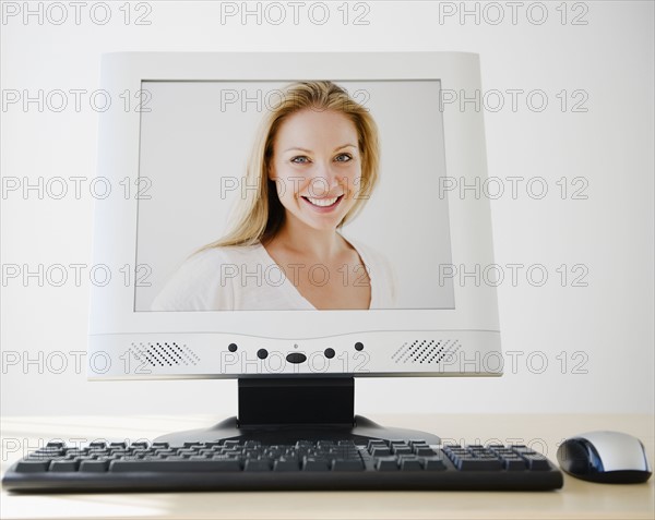 USA, New Jersey, Jersey City, PC flat screen showing attractive young woman. Photo : Jamie Grill Photography