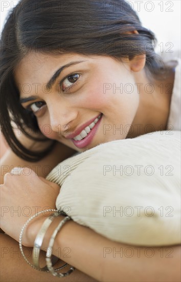 USA, New Jersey, Jersey City, Attractive young woman embracing pillow. Photo : Daniel Grill
