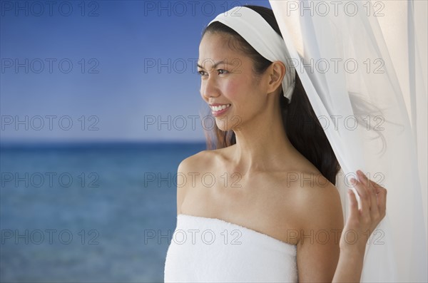 USA, New Jersey, Jersey City, Woman wrapped in towel near sea.