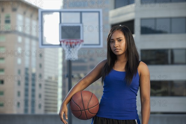USA, Utah, Salt Lake City, young woman holding basketball. Photo : Mike Kemp