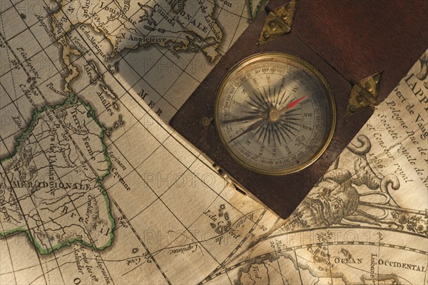 Antique compass on map.