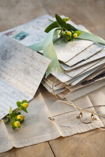 Flowers on pile of letters.