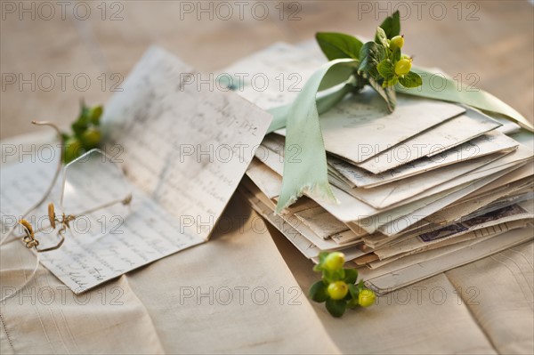 Flowers on pile of letters.