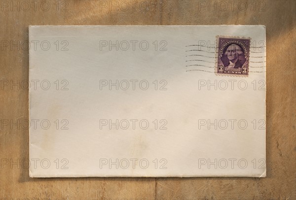 Blank envelope on wooden table.