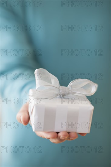 USA, New Jersey, Jersey City, Man holding gift box in front of him.