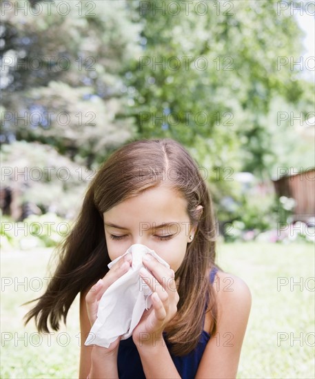 USA, New York, Girl (10-11) blowing nose. Photo : Jamie Grill Photography