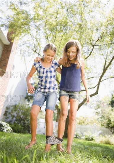 USA, New York, Two girls (10-11, 10-11) playing in backyard. Photo : Jamie Grill Photography