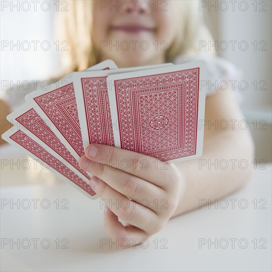 USA, New Jersey, Jersey City, Girl (8-9) playing cards. Photo : Jamie Grill Photography