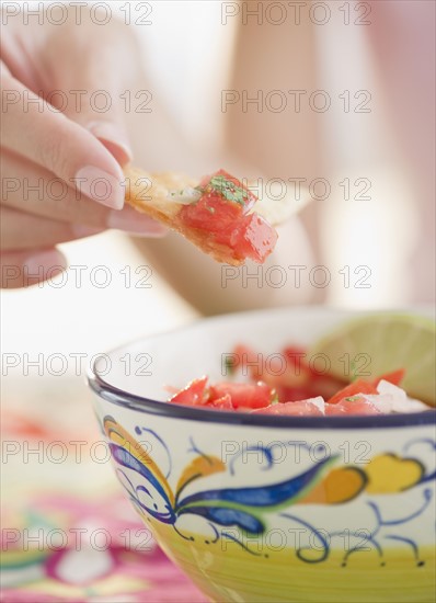 USA, New Jersey, Jersey City, Close-up view of woman's hand eating salad with cracker. Photo : Jamie Grill Photography