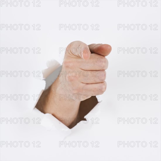 Hand on white background pointing. Photo : Daniel Grill