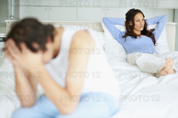 South Africa, Young couple in bedroom after quarrel. Photo : momentimages