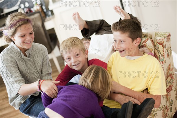 USA, Utah, Portrait of kids (2-3, 6-7, 10-11, 10-11) playing in living room. Photo : Tim Pannell