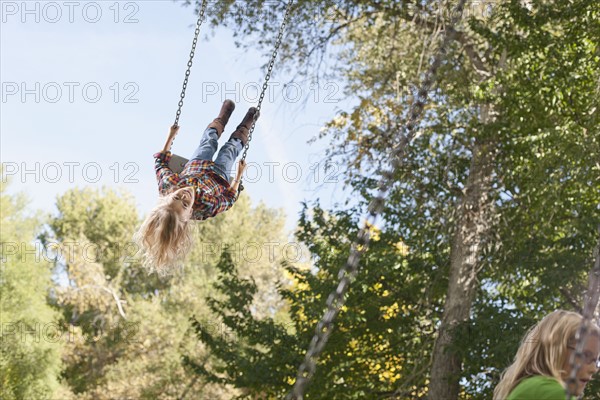USA, Utah, girl (6-7)swinging on tree swing. Photo : Tim Pannell