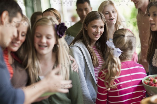 Girls (10-11, 14-15) with family during celebration event. Photo : Tim Pannell