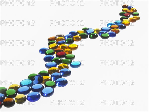 Studio shot of colorful glass beads in row. Photo : David Arky